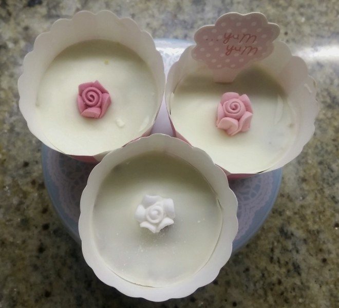 Lolly cake mix pushed into fancy cupcake cases then melted white chocolate on top with purchased roses placed with tweezers. 