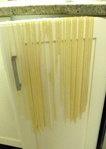 Hanging pasta on cupboard door to dry